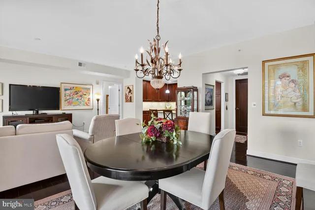 a view of a dining room with furniture and chandelier