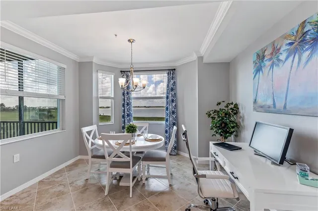 a dining room with furniture a chandelier and window