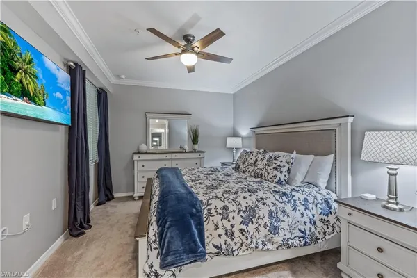 a bedroom with a bed and a lamp on dresser