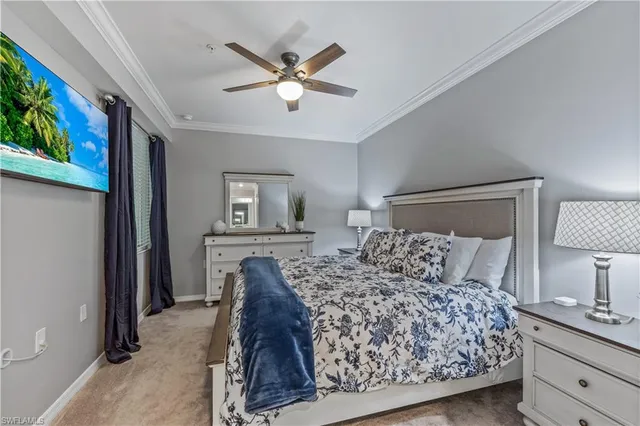 a bedroom with a bed and a lamp on dresser