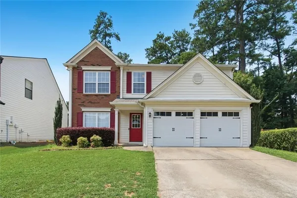a front view of a house with a yard