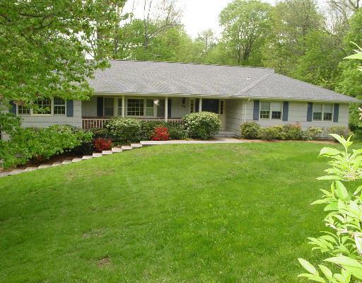 19 Holmes Road Ridgefield, CT 06877 - Photo 1 of 1 a front view of a house with a garden