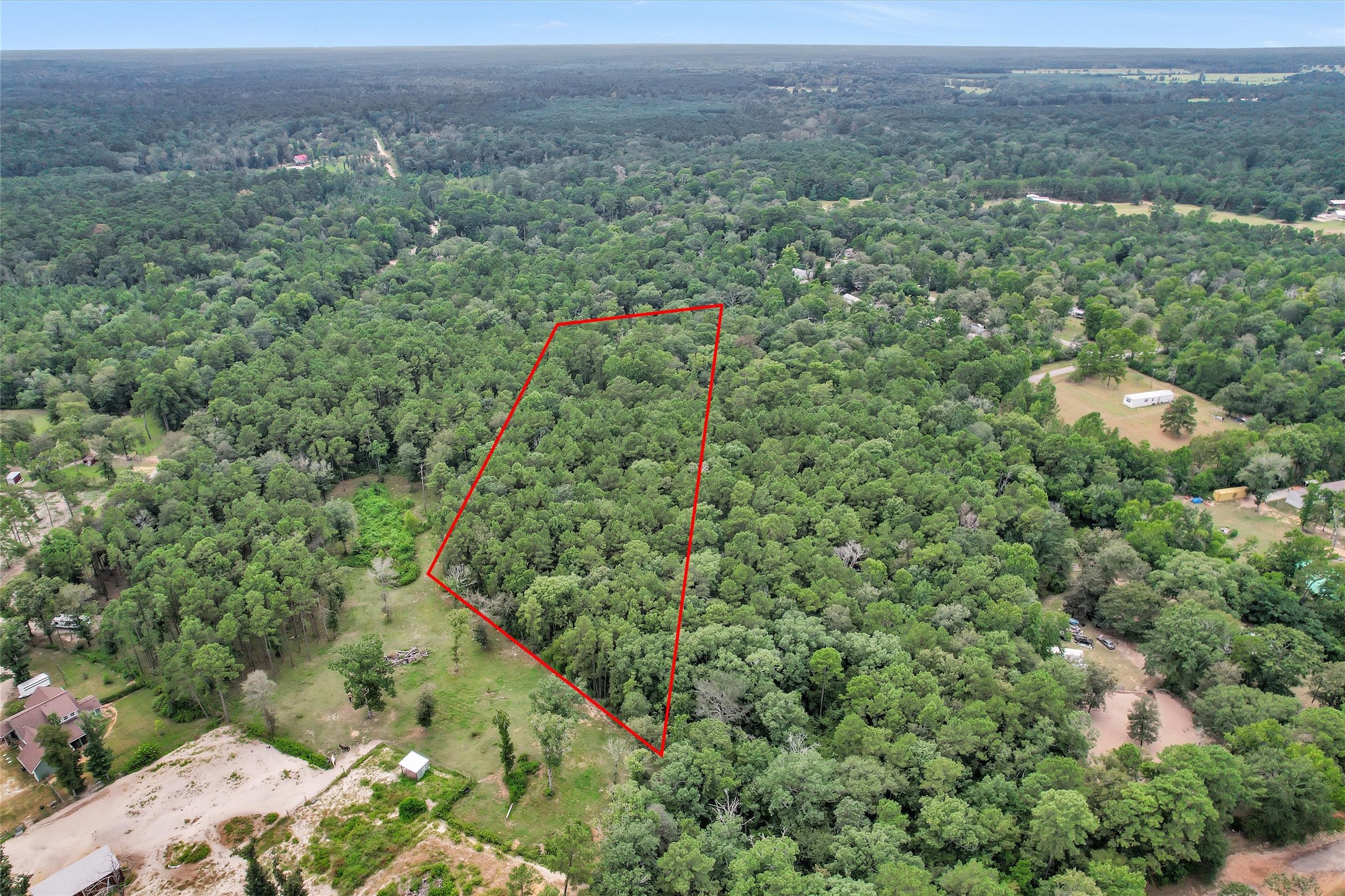Lot 21 East Double Crk Road Willis, TX 77378 - Photo 1 of 12 an aerial view of a houses with a lush green hillside