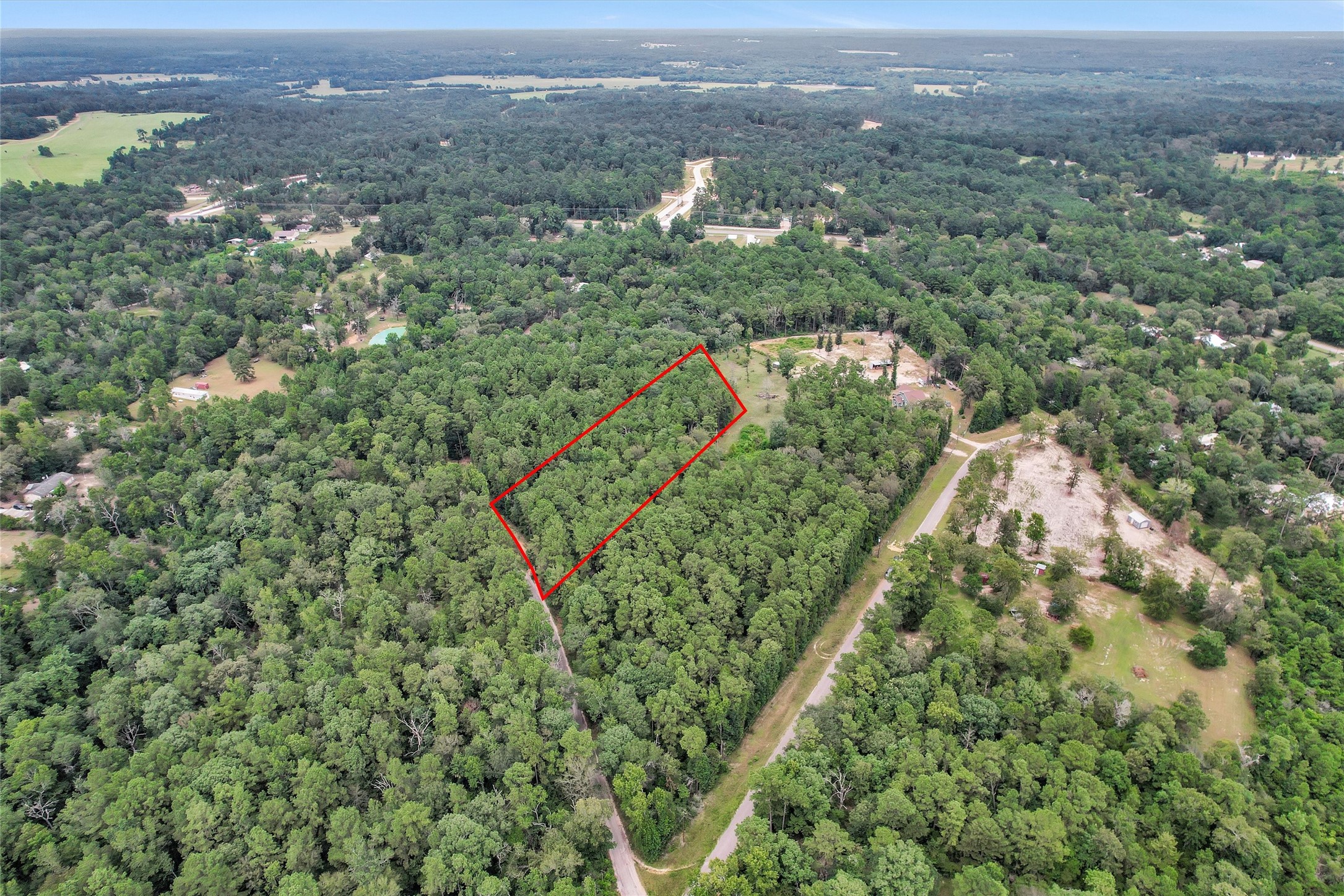 Lot 21 East Double Crk Road Willis, TX 77378 - Photo 11 of 12 an aerial view of residential houses with outdoor space and trees
