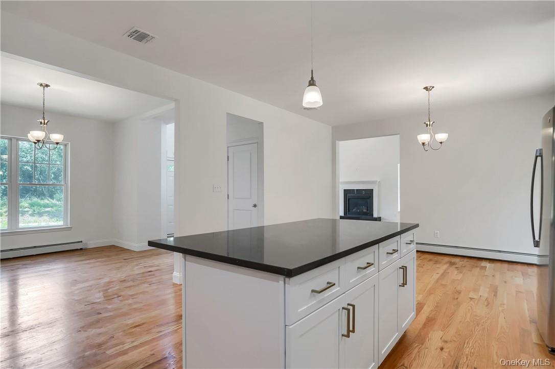 Lot 14-31 Sawyer Way Wallkill, NY 12589 - Photo 12 of 31 a kitchen with granite countertop a sink a counter space and a refrigerator