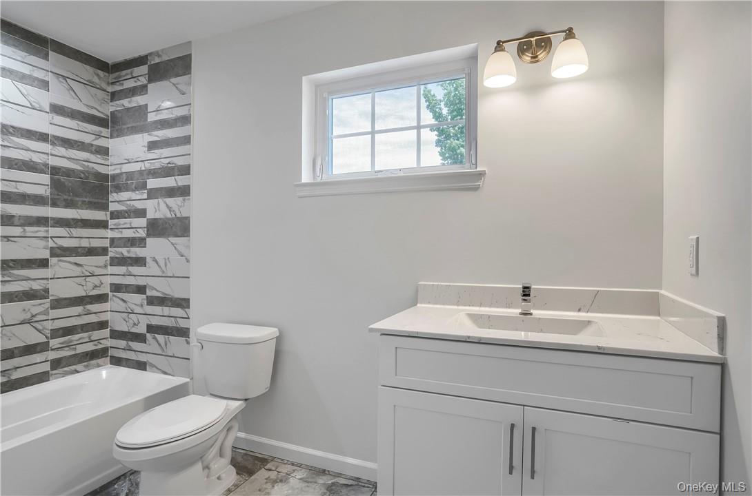 Lot 14-31 Sawyer Way Wallkill, NY 12589 - Photo 24 of 31 a bathroom with a sink a toilet and a mirror