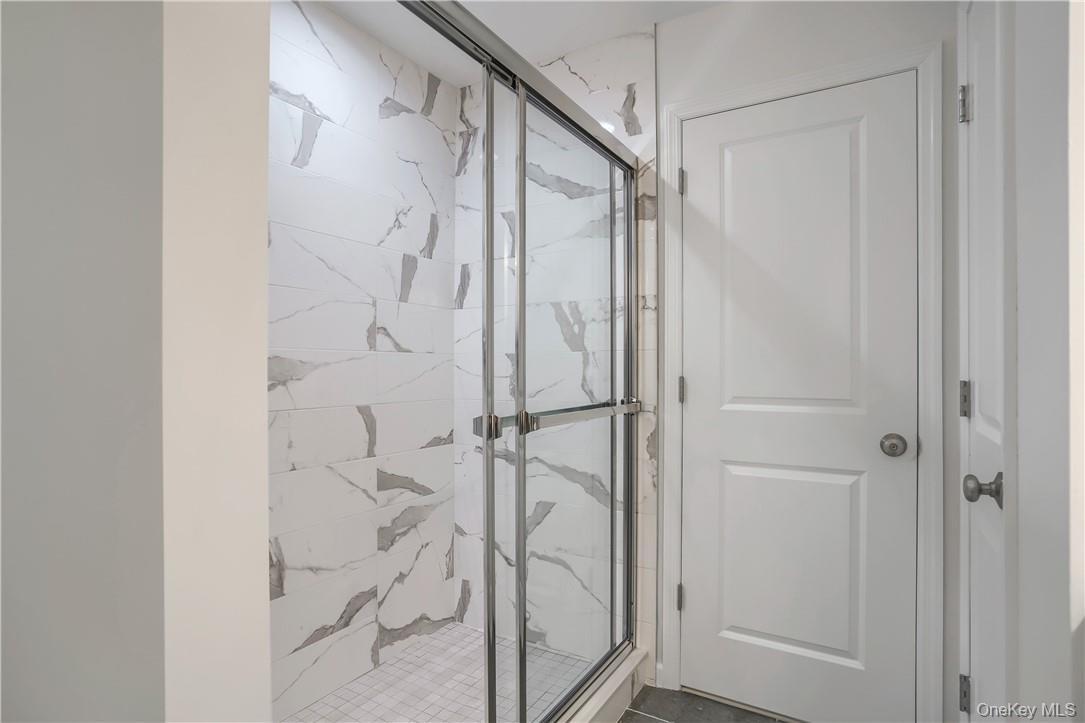 Lot 14-31 Sawyer Way Wallkill, NY 12589 - Photo 29 of 31 a bathroom with a glass shower door