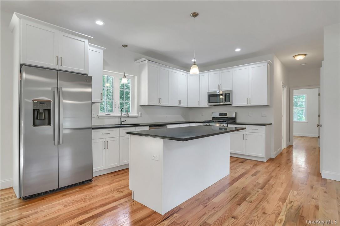 Lot 14-31 Sawyer Way Wallkill, NY 12589 - Photo 9 of 31 a kitchen with stainless steel appliances granite countertop a refrigerator a sink and a stove