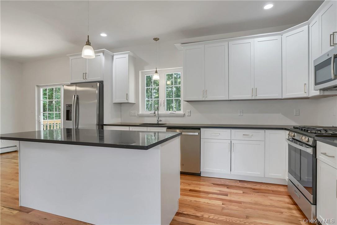 Lot 14-31 Sawyer Way Wallkill, NY 12589 - Photo 10 of 31 a kitchen with stainless steel appliances granite countertop a sink and a stove