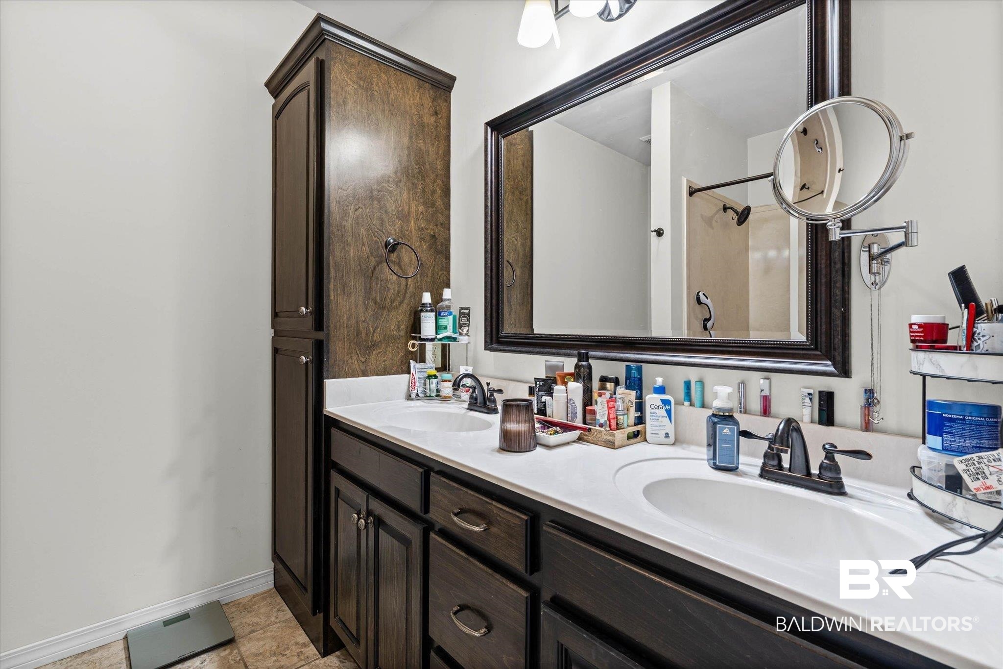 800 Galoway Avenue Mobile, AL 36609 - Photo 13 of 22 Dual vanity with white countertops, dark wood cabinetry, integrated sinks, and bronze-finish fixtures