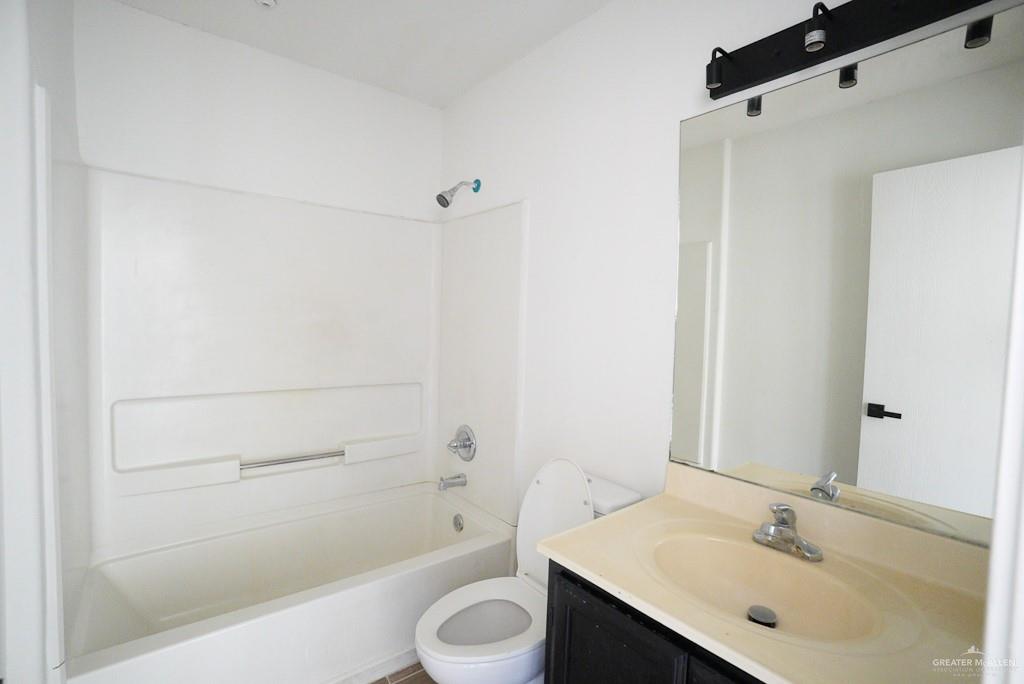 1602 East Rabbit Run Avenue Alton, TX 78573 - Photo 11 of 18 a bathroom with a sink toilet and shower