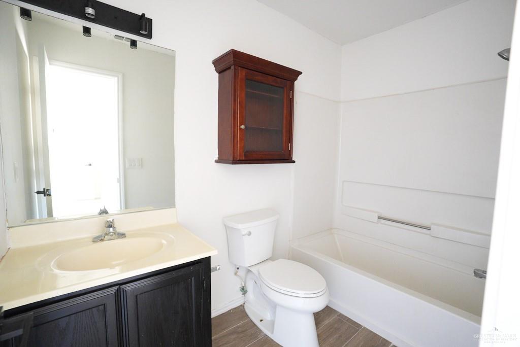 1602 East Rabbit Run Avenue Alton, TX 78573 - Photo 13 of 18 a bathroom with a sink a toilet and shower