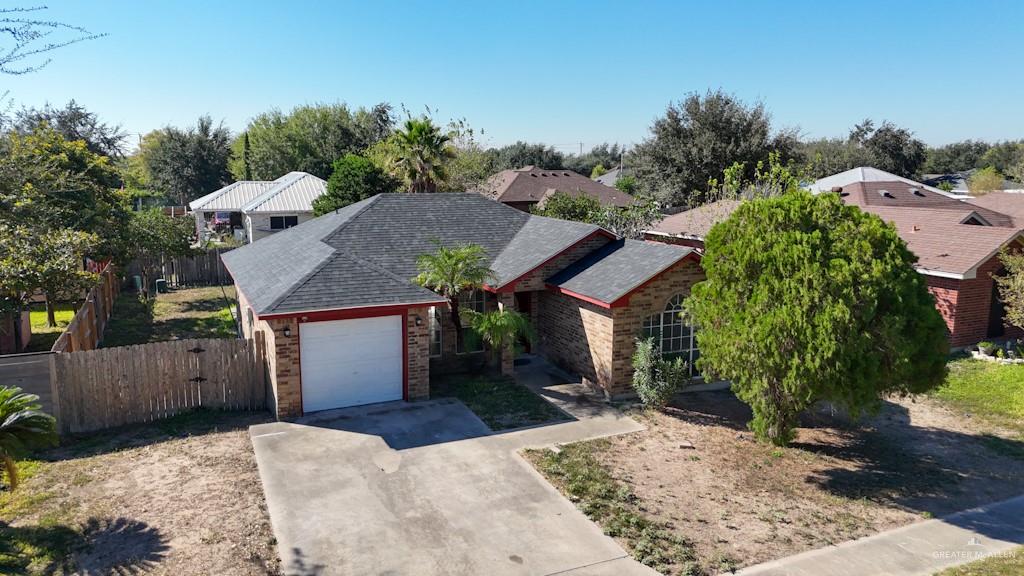 1602 East Rabbit Run Avenue Alton, TX 78573 - Photo 2 of 18 a view of a house with a yard and large tree