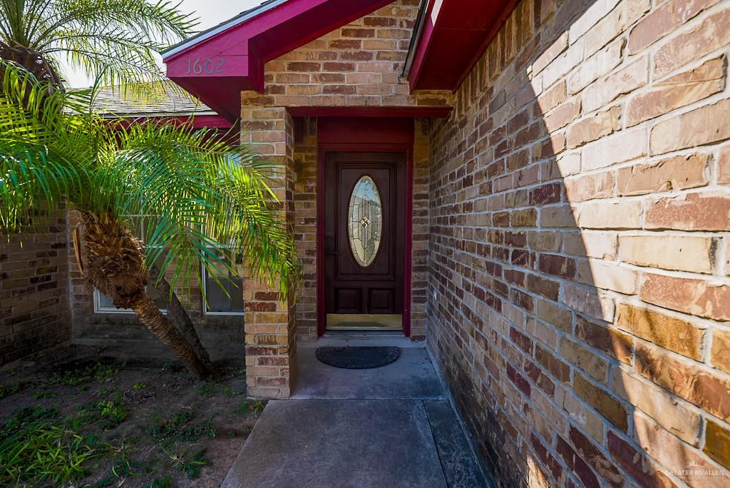 1602 East Rabbit Run Avenue Alton, TX 78573 - Photo 3 of 18 a front view of a house with garden