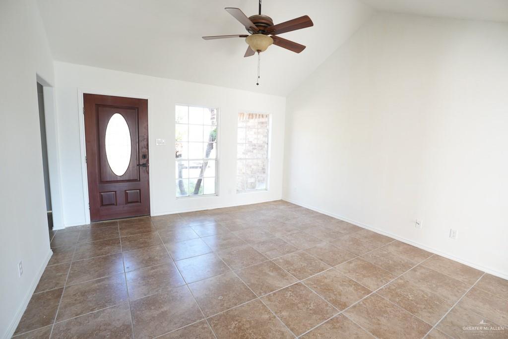 1602 East Rabbit Run Avenue Alton, TX 78573 - Photo 5 of 18 a view of a livingroom with a chandelier fan and a window