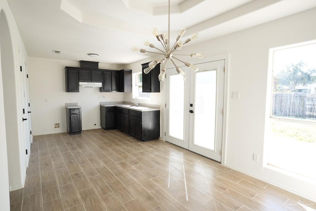 1602 East Rabbit Run Avenue Alton, TX 78573 - Photo 7 of 18 a view of a kitchen with a sink and a fireplace