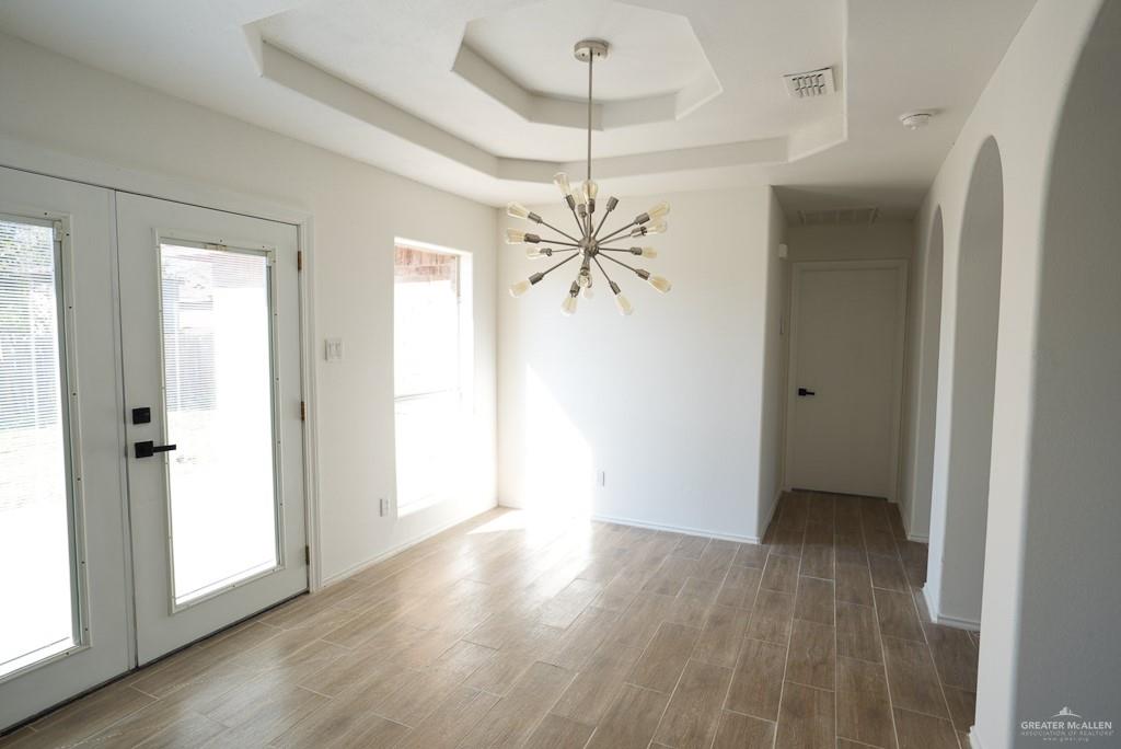 1602 East Rabbit Run Avenue Alton, TX 78573 - Photo 8 of 18 wooden floor in an empty room with a window