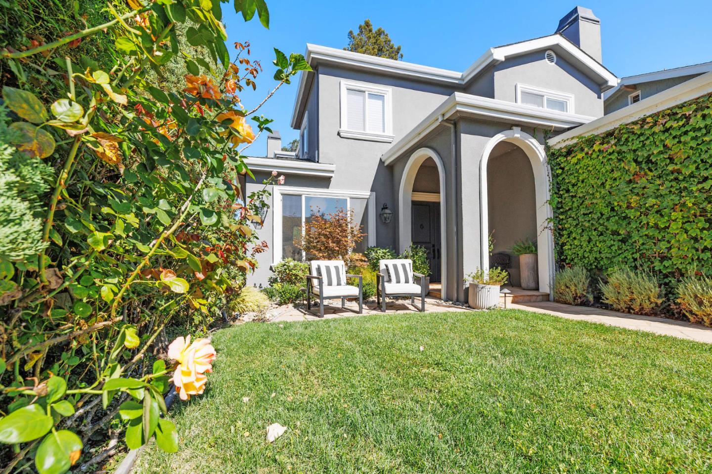 1330 Benito Avenue Burlingame, CA 94010 - Photo 4 of 60 a view of a white house with a big yard and potted plants