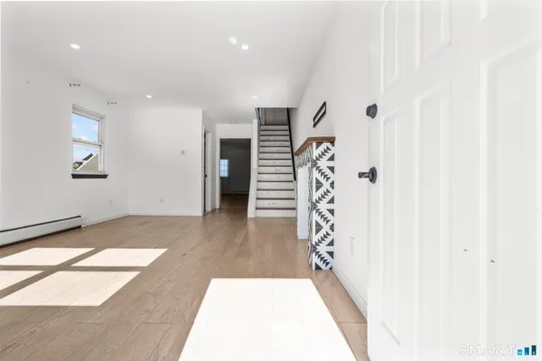 a view of an entryway with wooden floor