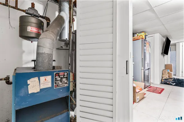 a view of a kitchen with fridge and workspace