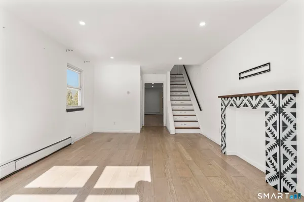 wooden floor in an empty room with a window