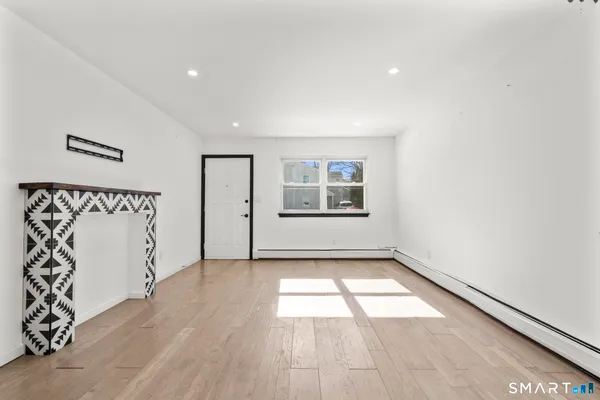 a view of a room with window and wooden floor