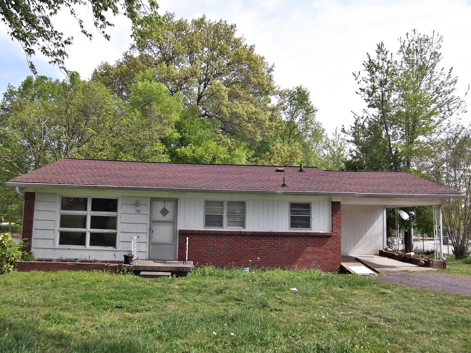 a front view of a house with a garden and porch