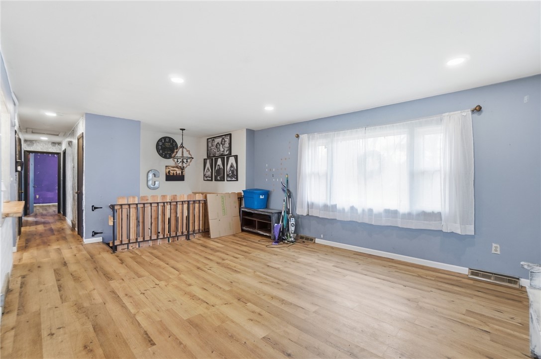 290 Ginghamsburg Road Tipp City, OH 45371 - Photo 8 of 49 Bright and airy, this living space features durable wood flooring and ample natural light.