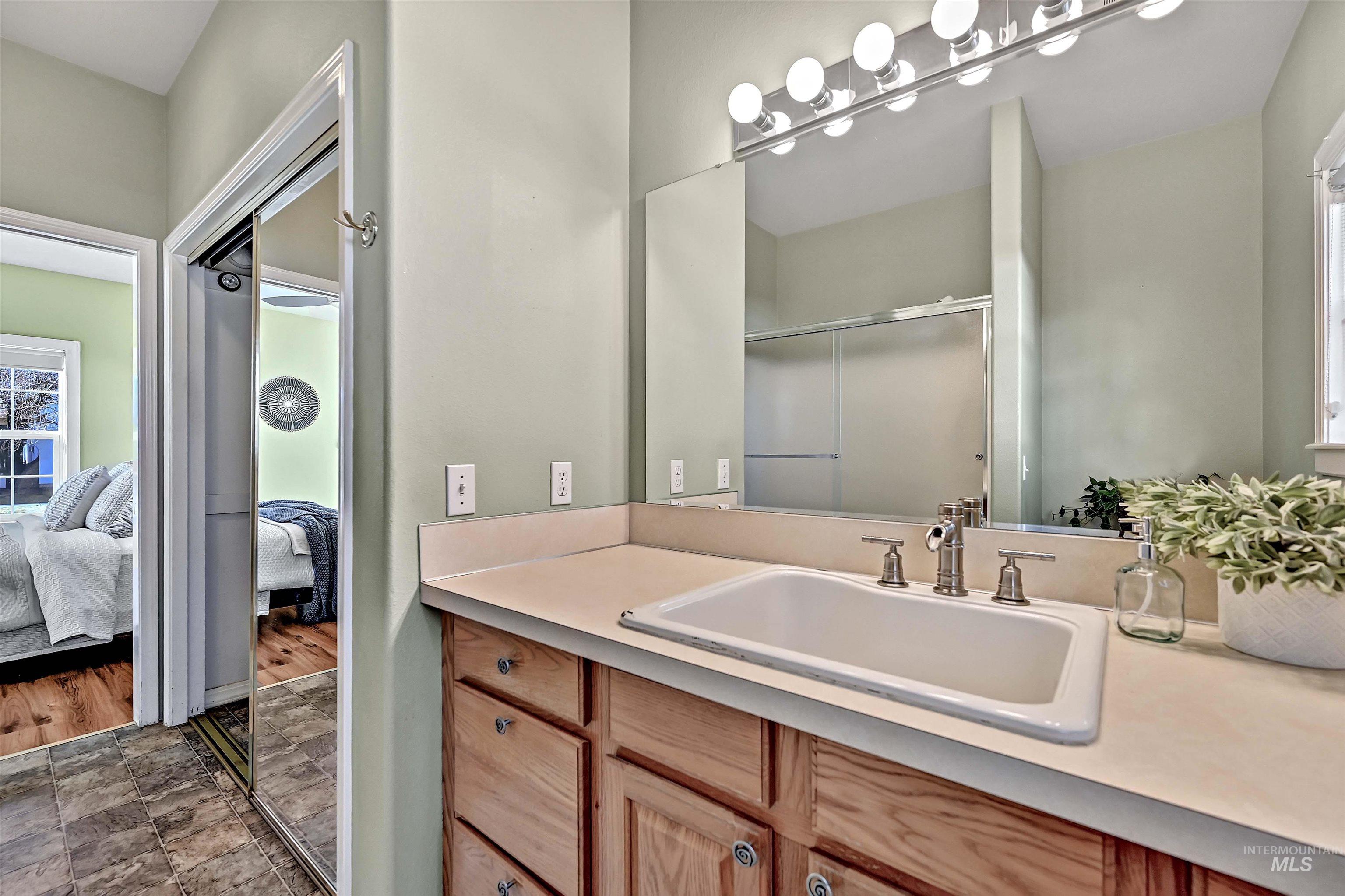 1902 West Washington Street Boise, ID 83702 - Photo 19 of 43 Ensuite bathroom featuring vanity, a shower stall, and stone finish flooring