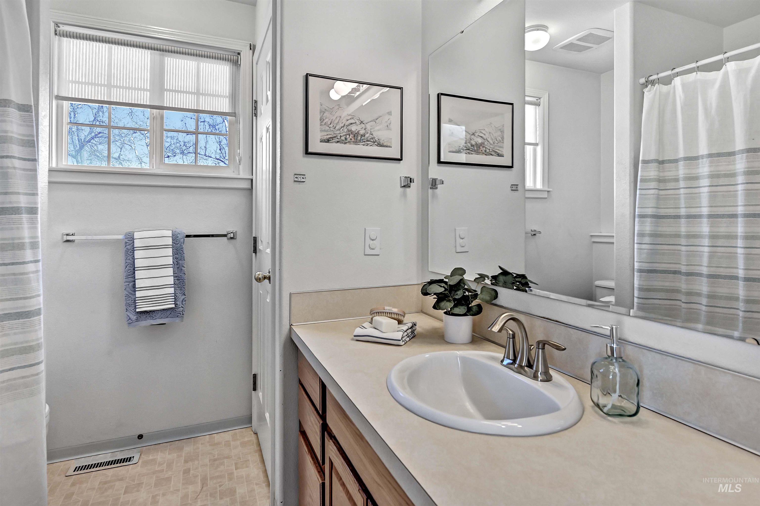 1902 West Washington Street Boise, ID 83702 - Photo 24 of 43 Full bathroom with a shower with curtain, vanity, and light floors