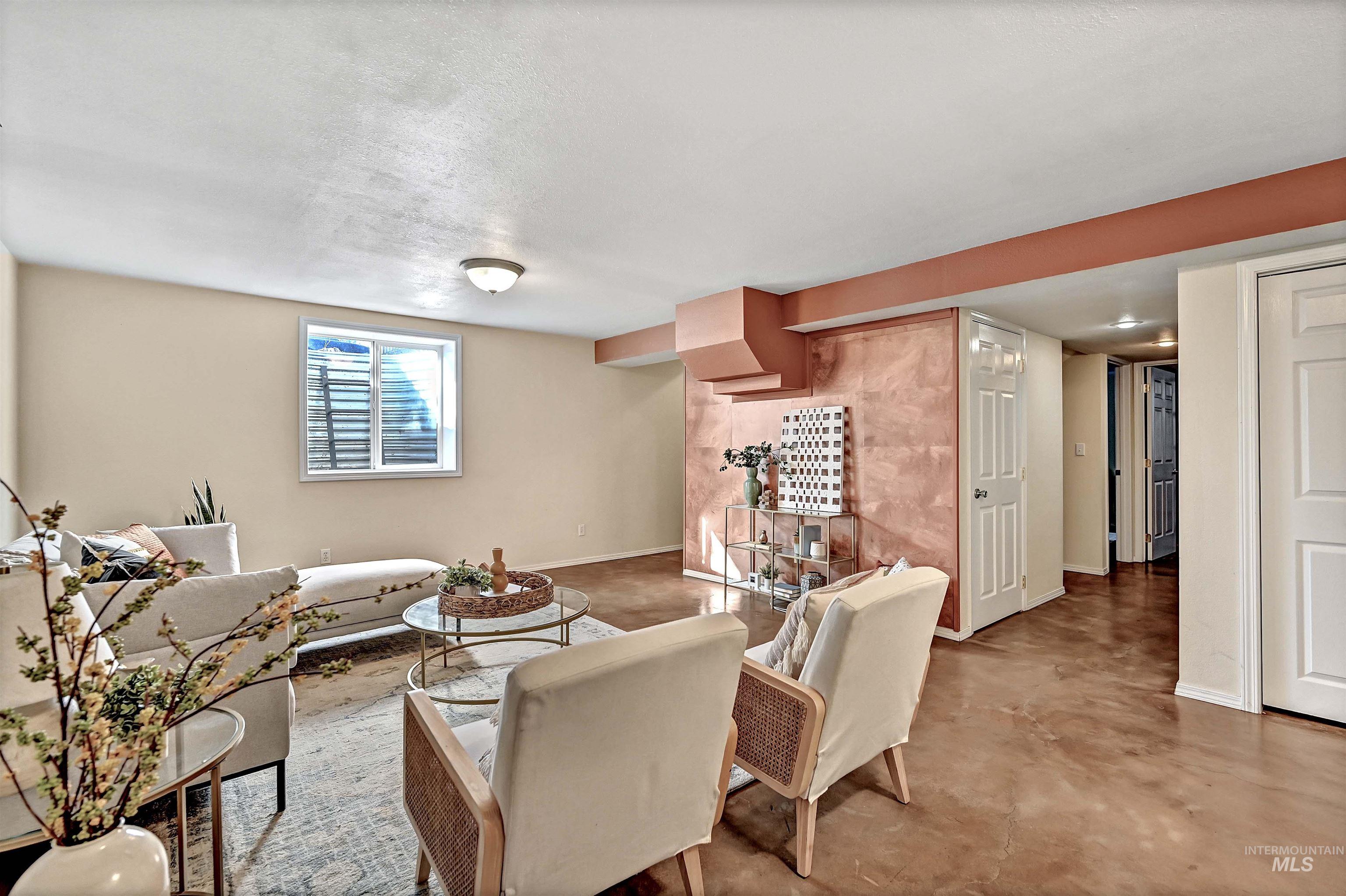 1902 West Washington Street Boise, ID 83702 - Photo 26 of 43 Family room featuring finished concrete floors and baseboards