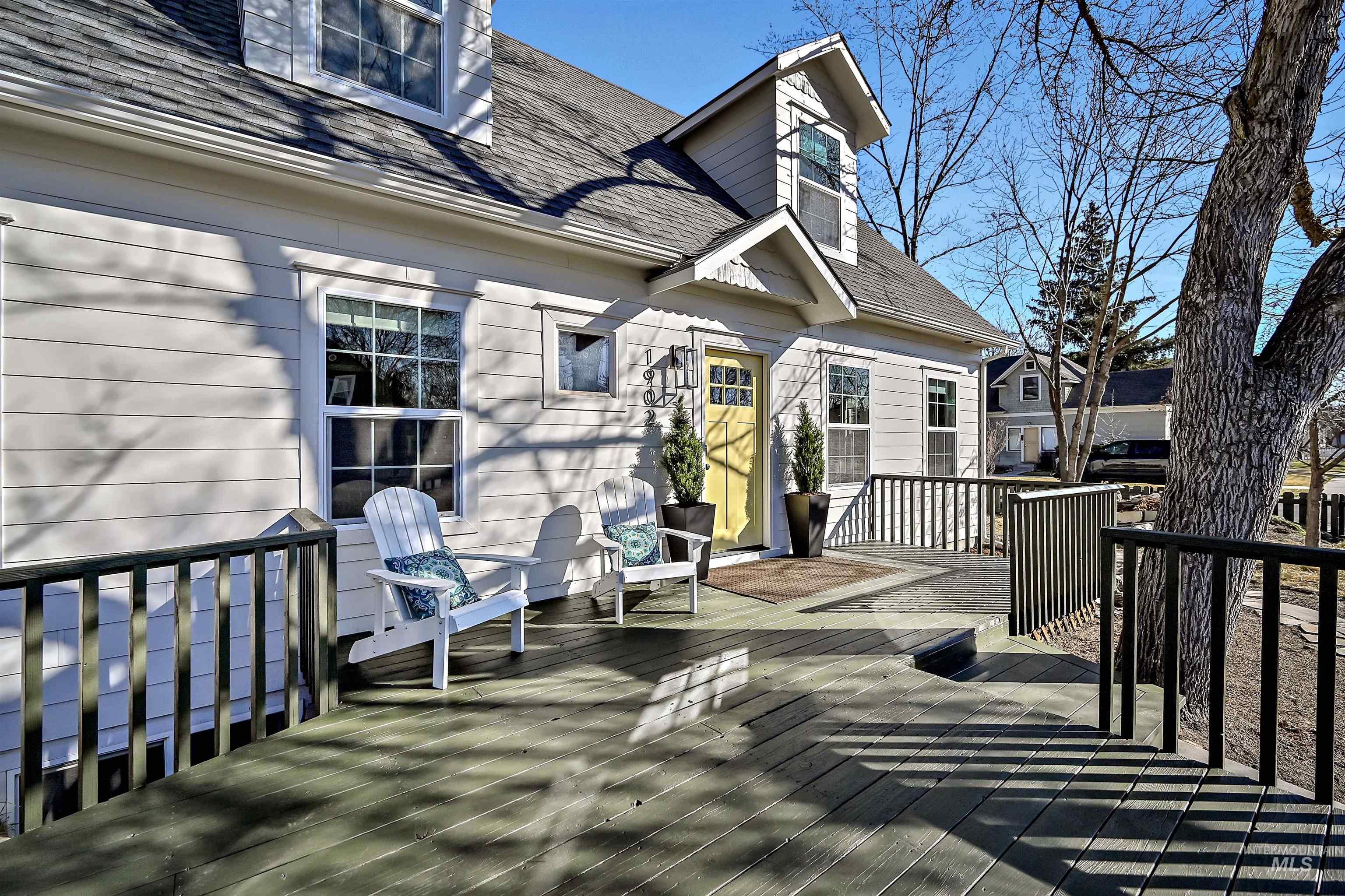 1902 West Washington Street Boise, ID 83702 - Photo 3 of 43 New england style home featuring a fenced backyard, a shingled roof, and a wooden deck