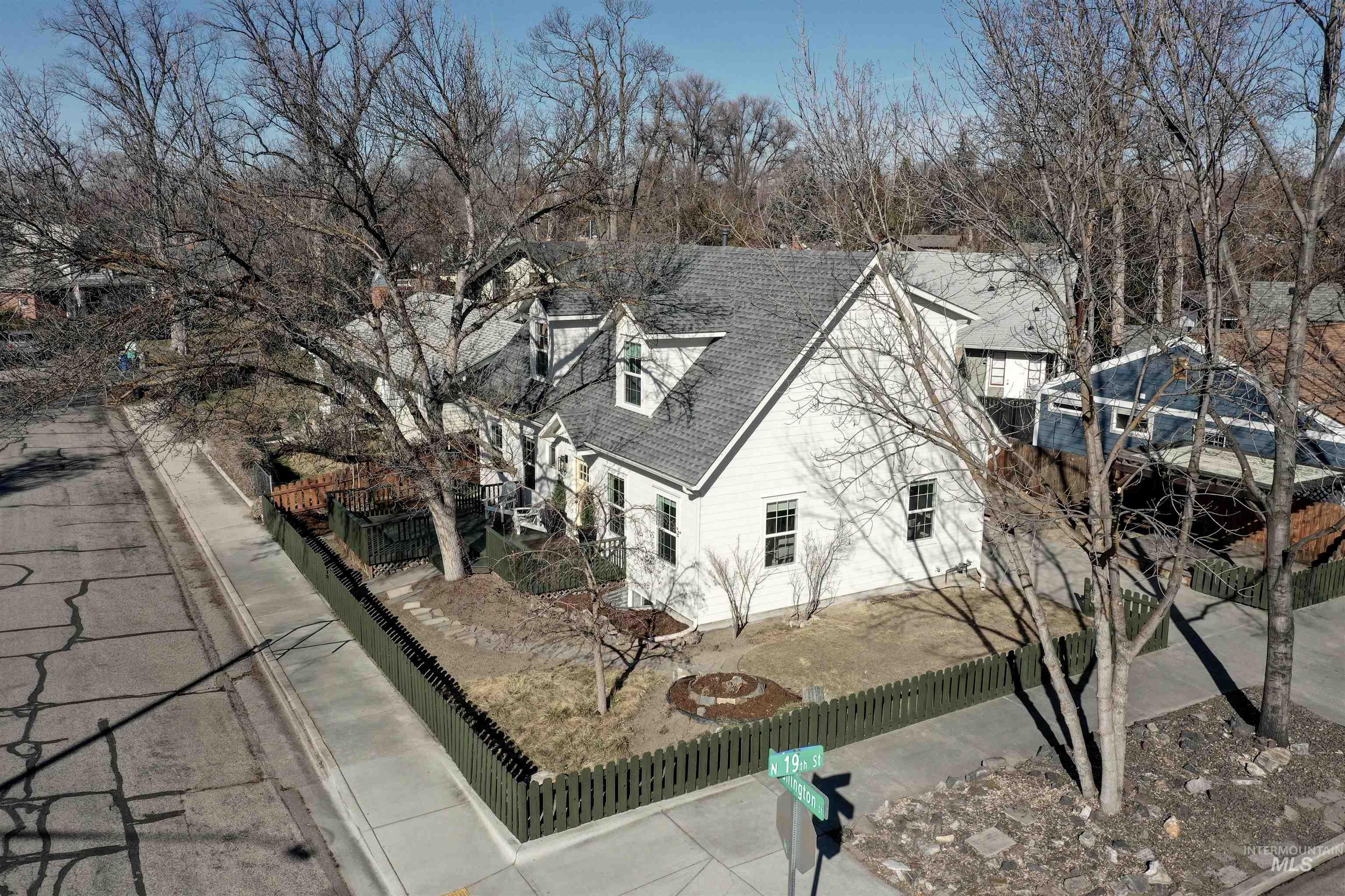 1902 West Washington Street Boise, ID 83702 - Photo 42 of 43 View of property exterior featuring a shingled roof and view of wooded area