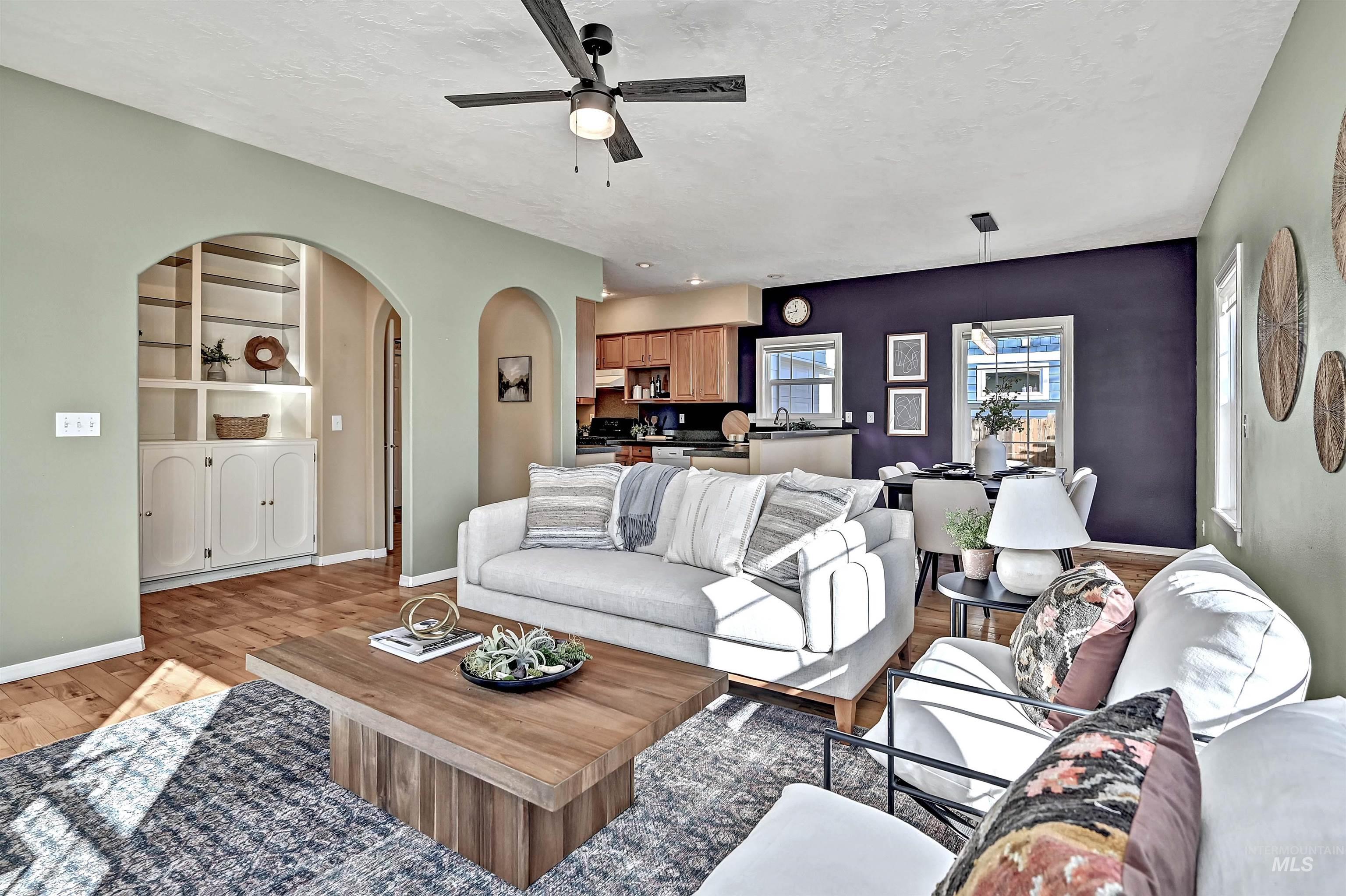 1902 West Washington Street Boise, ID 83702 - Photo 6 of 43 Living room featuring light wood finished floors, ceiling fan, arched walkways, and a textured ceiling