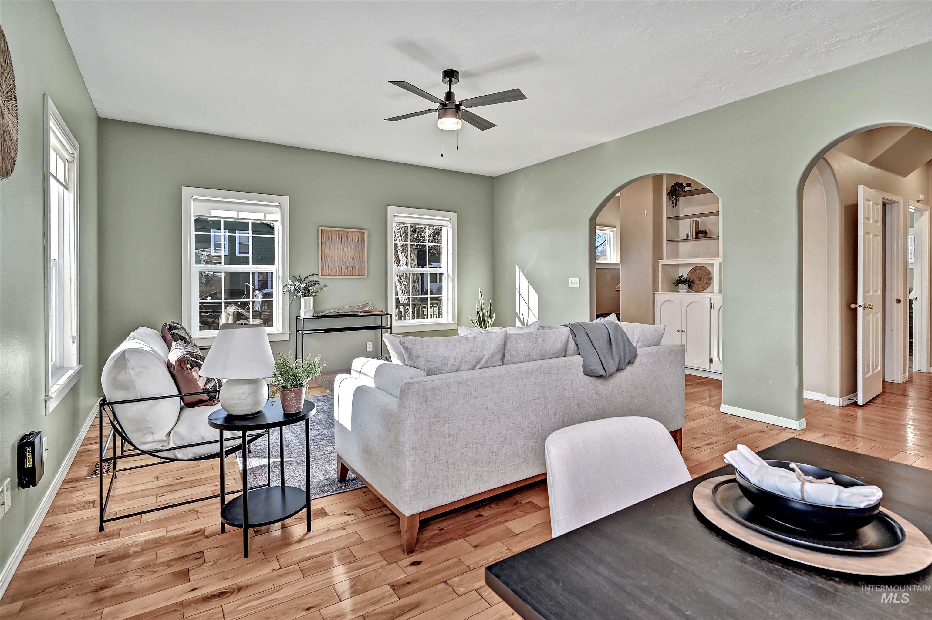 1902 West Washington Street Boise, ID 83702 - Photo 7 of 43 Living area with a ceiling fan, light wood-type flooring, built in shelves, and arched walkways