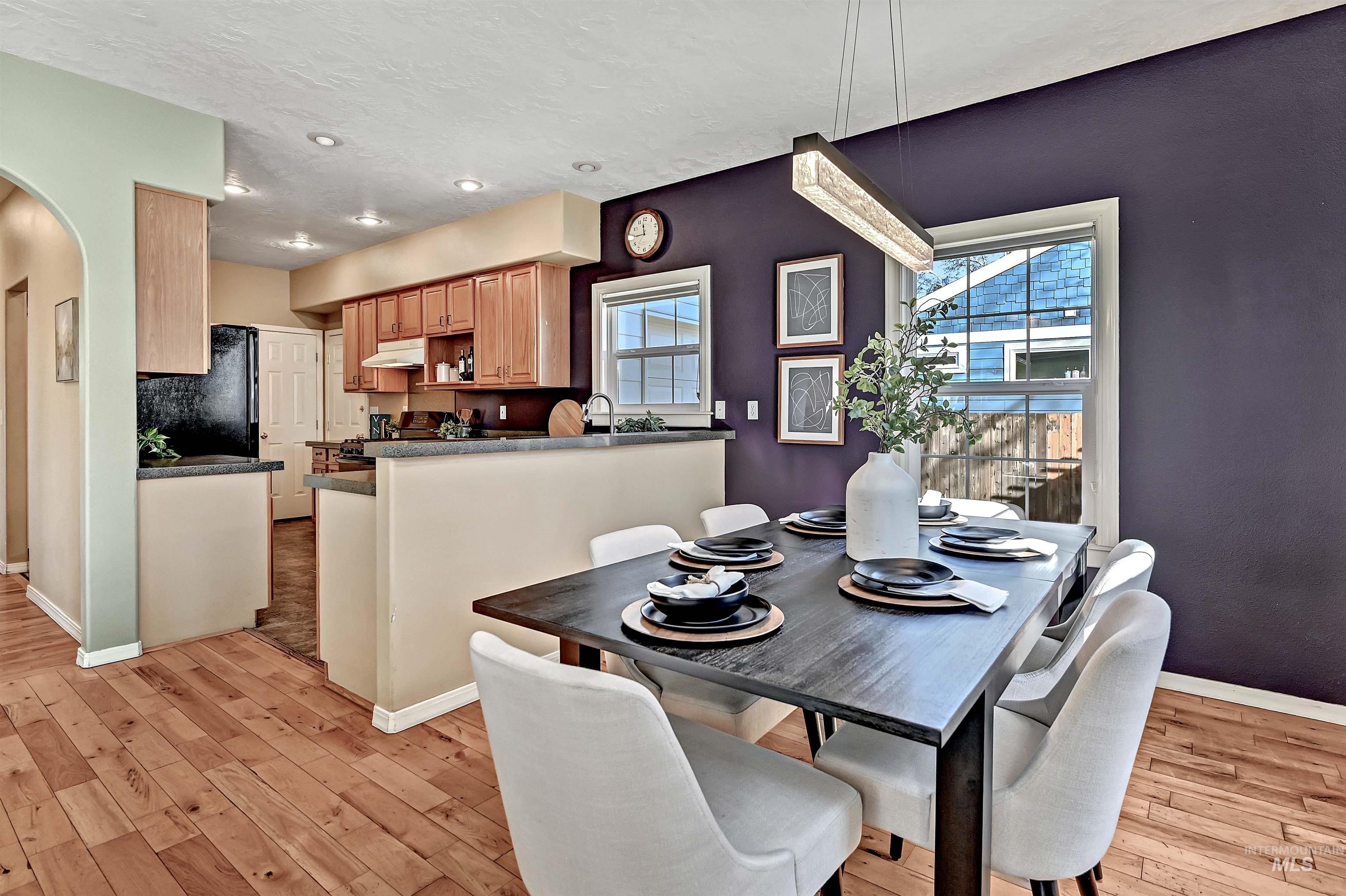 1902 West Washington Street Boise, ID 83702 - Photo 8 of 43 Dining space with arched walkways, light wood finished floors, and a textured ceiling