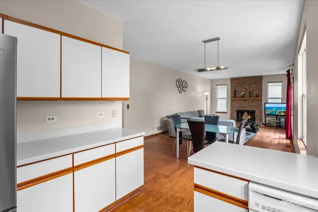 a kitchen with stainless steel appliances granite countertop a sink a stove and white cabinets