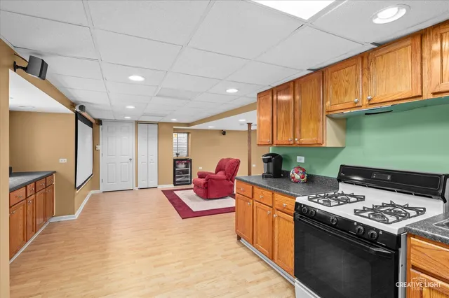 a kitchen with stainless steel appliances granite countertop a stove a sink dishwasher and a refrigerator