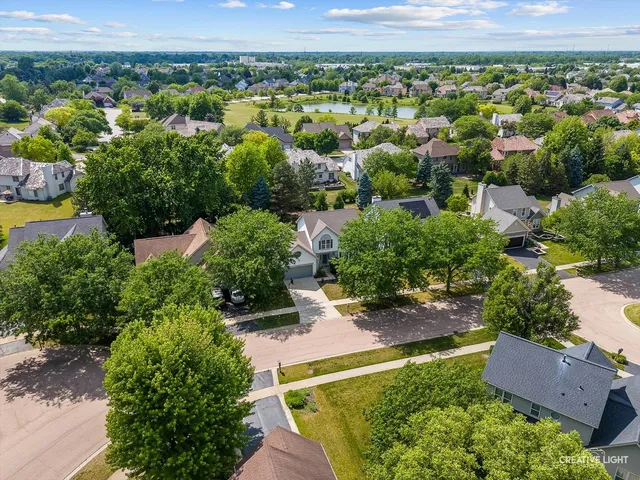 an aerial view of a house with a yard