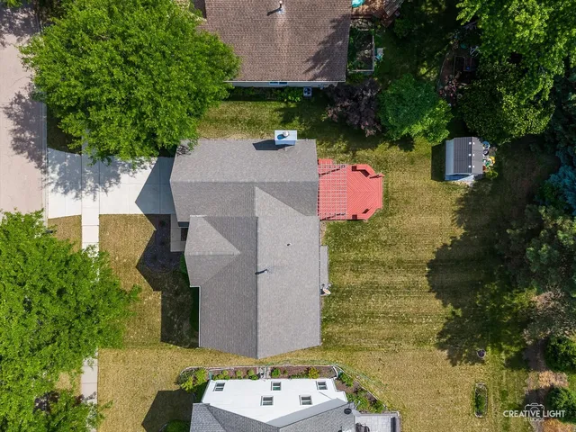 an aerial view of a house with a yard