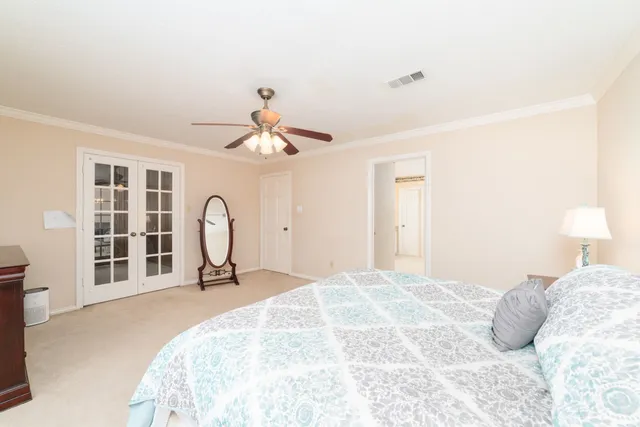 a bedroom with a bed and a chandelier