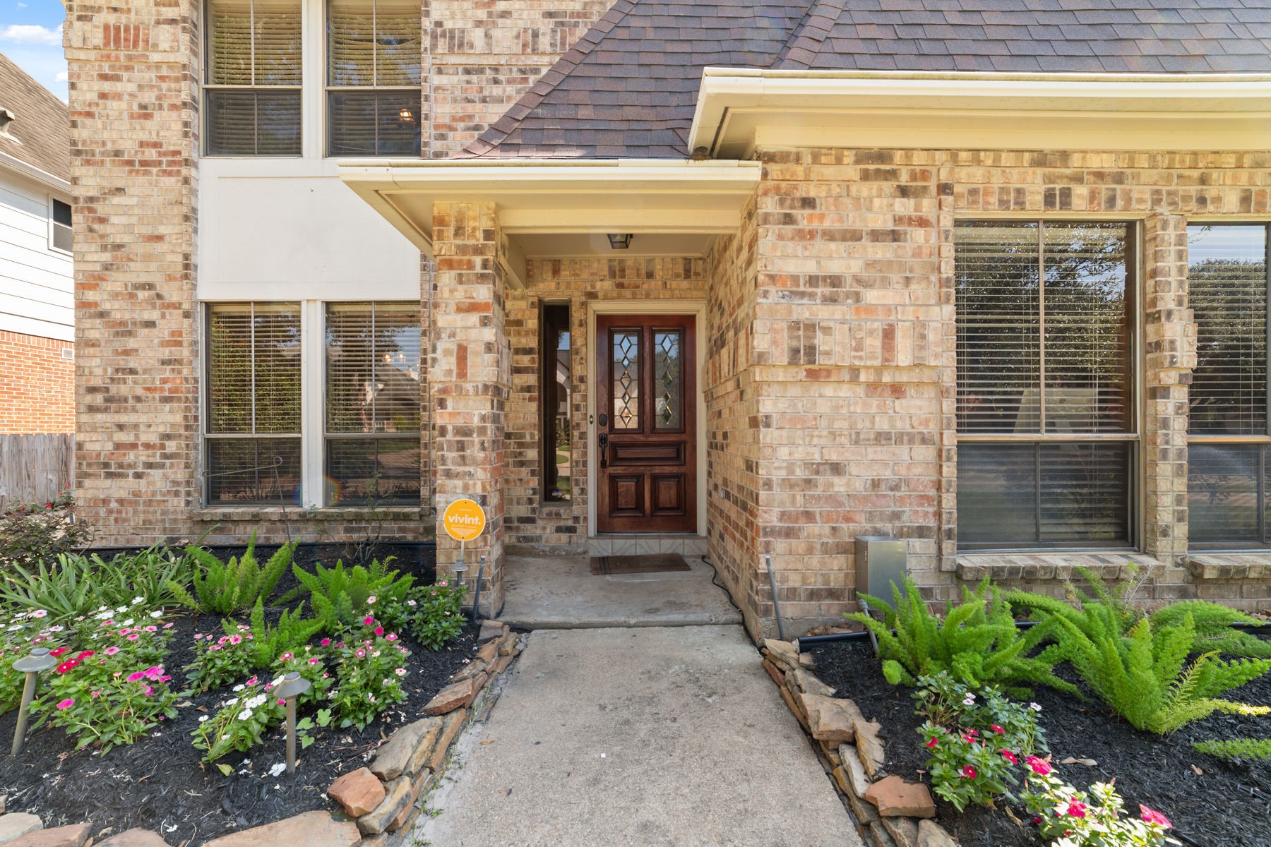 14931 Inverrary Drive Houston, TX 77095 - Photo 2 of 33 a front view of a house with a garden