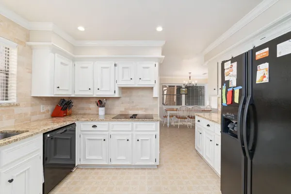 a kitchen with stainless steel appliances a stove refrigerator sink and cabinets