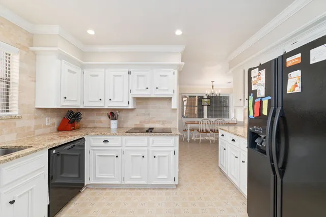 a kitchen with stainless steel appliances a stove refrigerator sink and cabinets