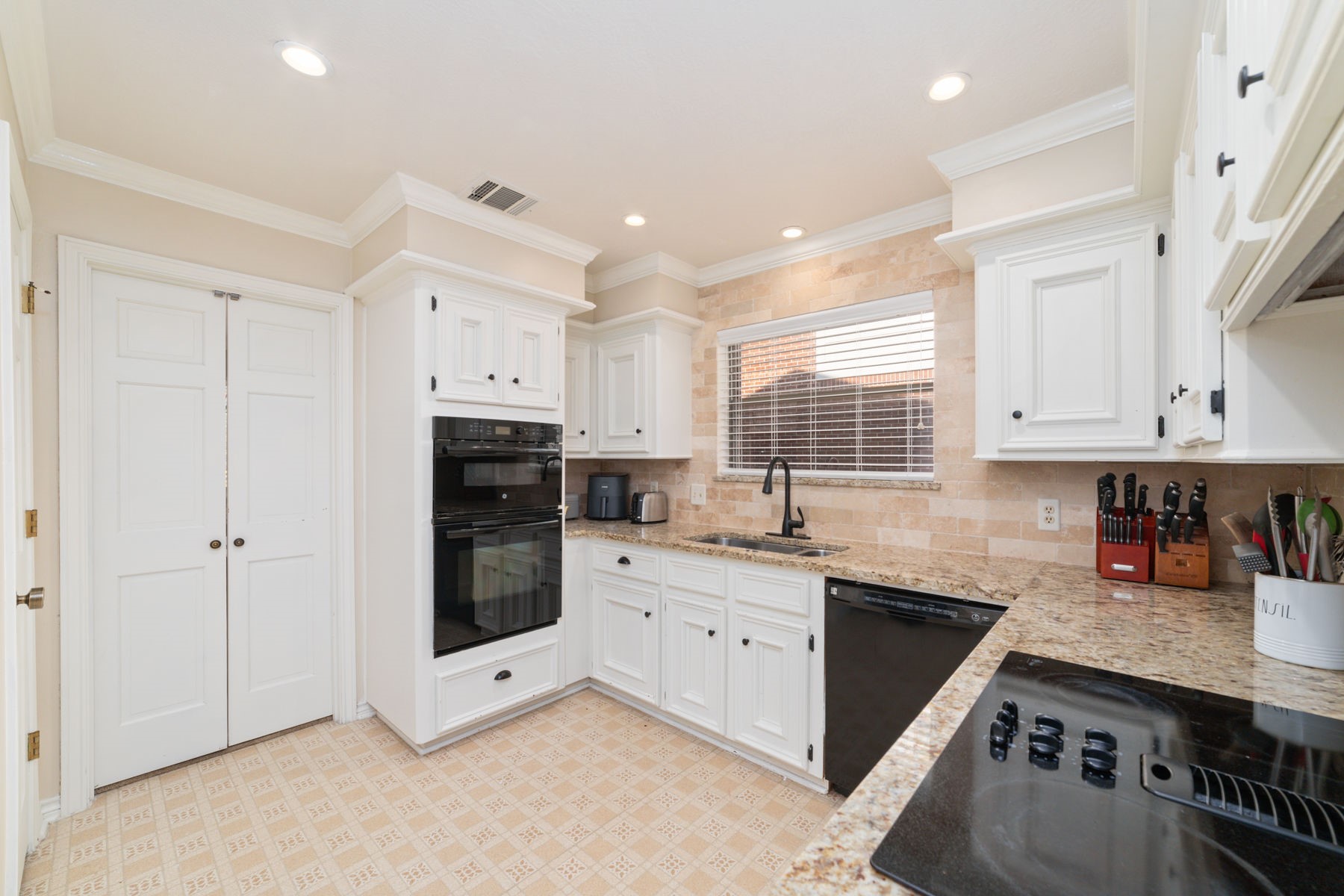 14931 Inverrary Drive Houston, TX 77095 - Photo 24 of 33 a kitchen with stainless steel appliances granite countertop a stove sink and cabinets