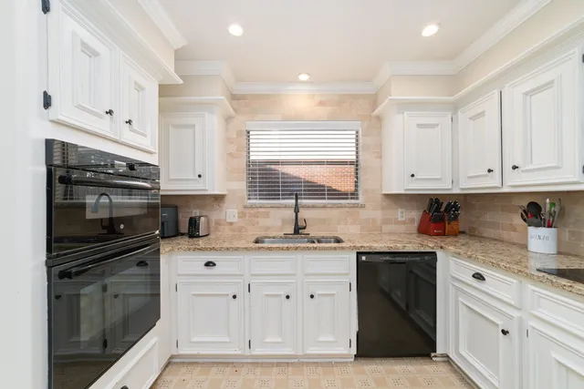 a kitchen with stainless steel appliances white cabinets and a sink