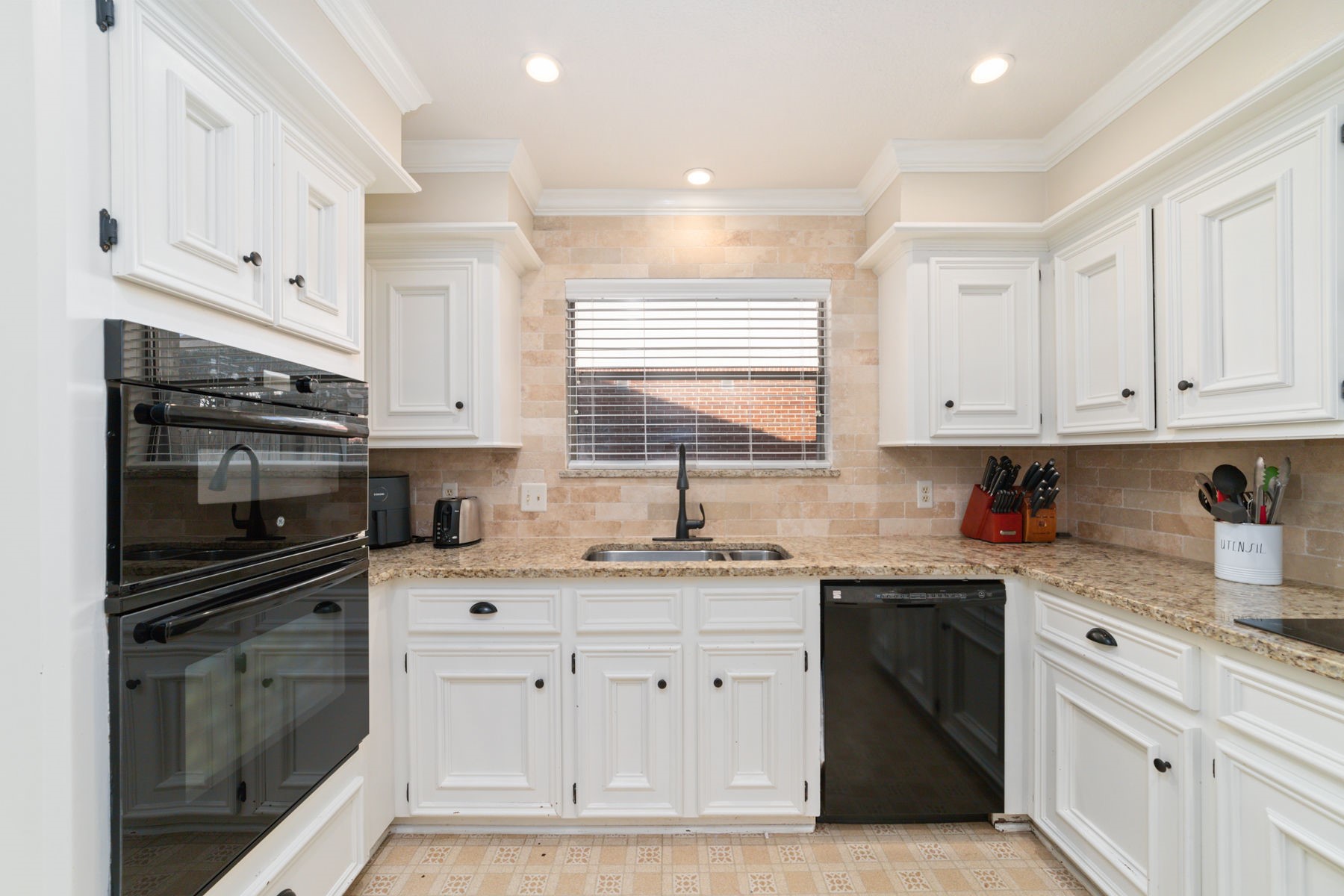 14931 Inverrary Drive Houston, TX 77095 - Photo 26 of 33 a kitchen with stainless steel appliances white cabinets and a sink