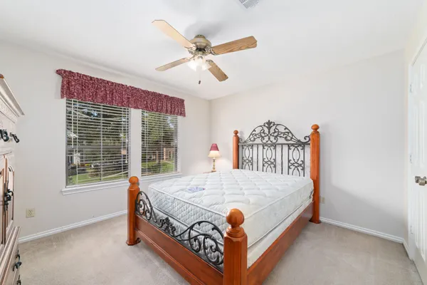 a bed sitting in a bedroom next to a window