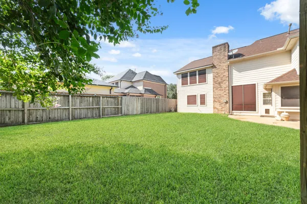 a view of a house with a backyard