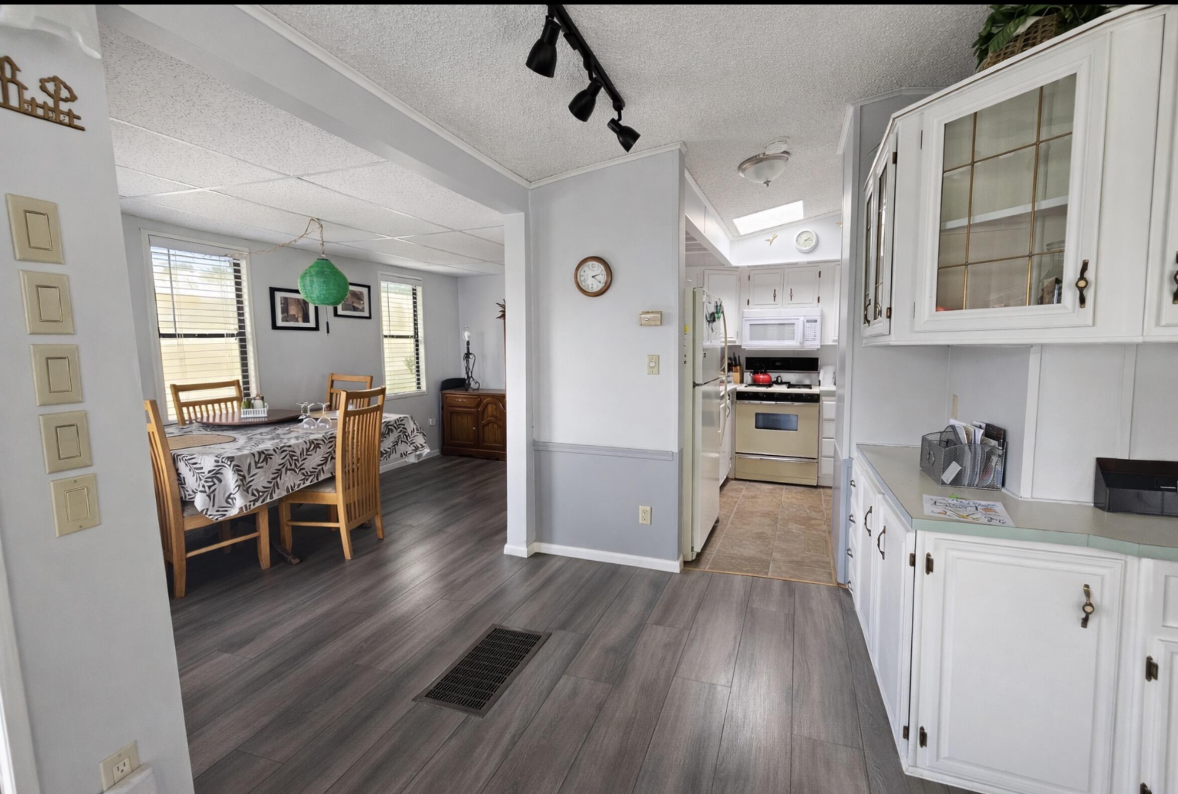a view of a kitchen and dining room with wooden floor